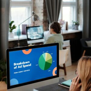 Bright office setting with computers displaying data, illustrating productivity in a workspace.